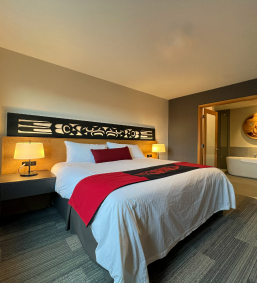 A beautiful king size bed with red and white pillow